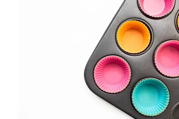 Top view muffin pan with silicone muffin cups white background  Flip 2019