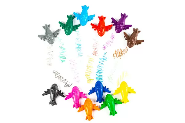 Top view, multi-colored set of crayons-airplanes on white