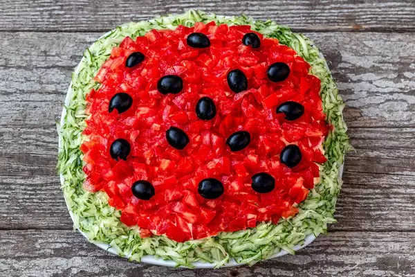 Top view Mushroom salad with tomatoes and cucumbers on an old wooden background