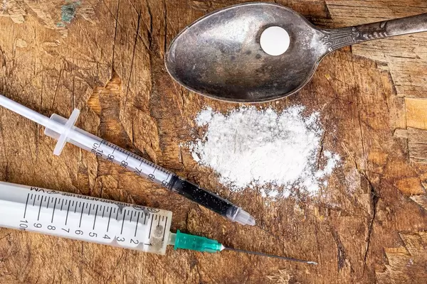Top view, narcotic substances and spoon on old wooden background