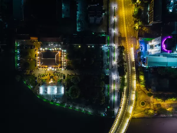 Top View Night Photo of the Ho Chi Minh Museum next to Khanh Hoi Bridge at Saigon River in District 4 in Ho Chi Minh City, Vietnam