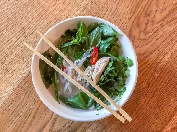Top view of a bowl of Pho Ga Vietnamese chicken soup