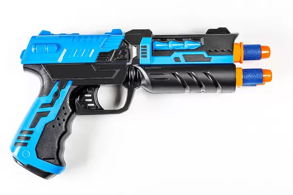 Top view of a toy child's gun on a white background (Flip 2020)