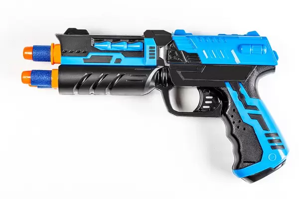 Top view of a toy child's gun on a white background