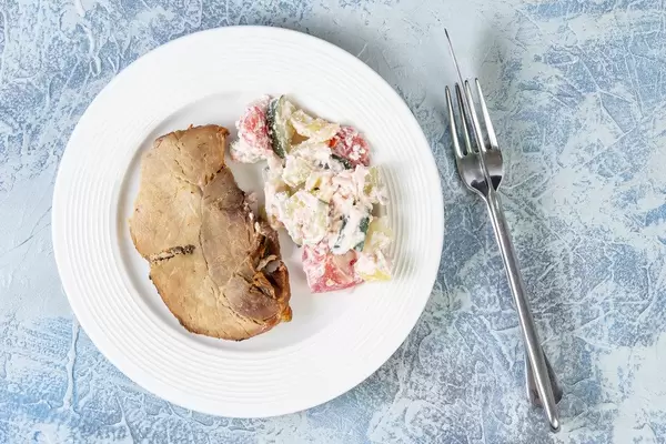 Top view of Baked Pork Chop with Serbian Sopska Salad (Flip 2019)