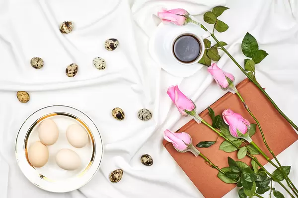 Top view of bright easter background with quail eggs and flowers