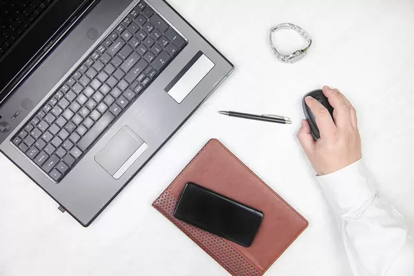 Top view of Businesman with mobile phone and lap top