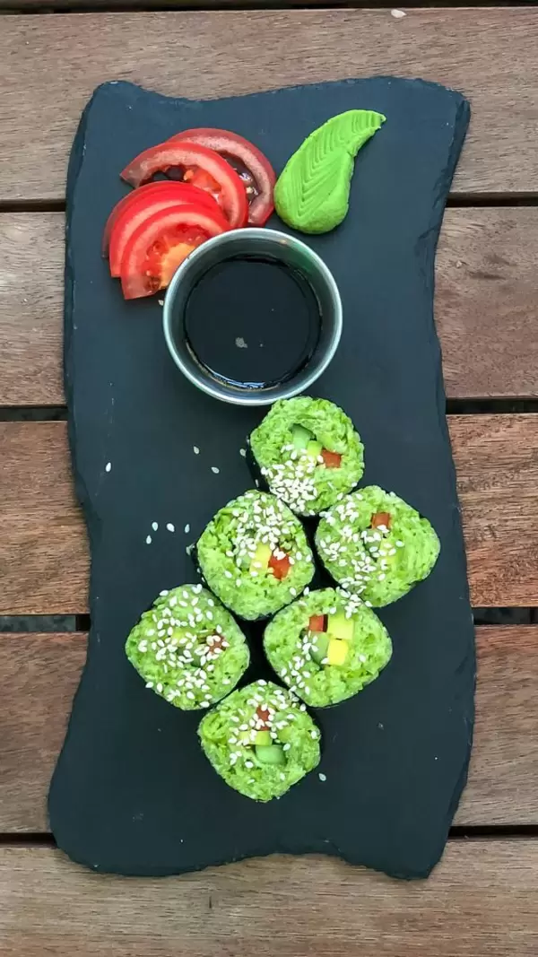Top view of California rolls served on black stone at Avocado Cafe