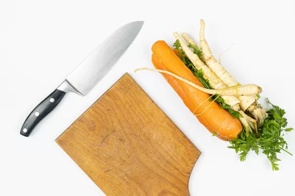 Top view of Carrot and Parsnip on the table with knife