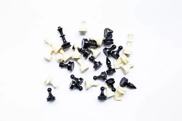 Top view of chess figures on white background