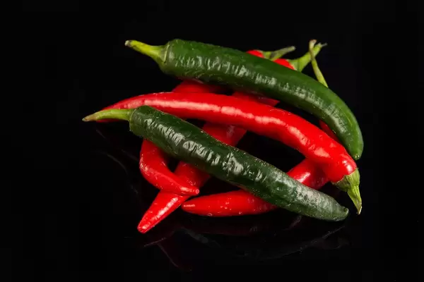 Top view of Chilli Hot Peppers above black background
