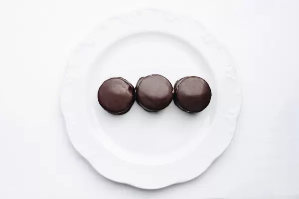 Top view of chocolate covered turkish dessert. Halva. White background