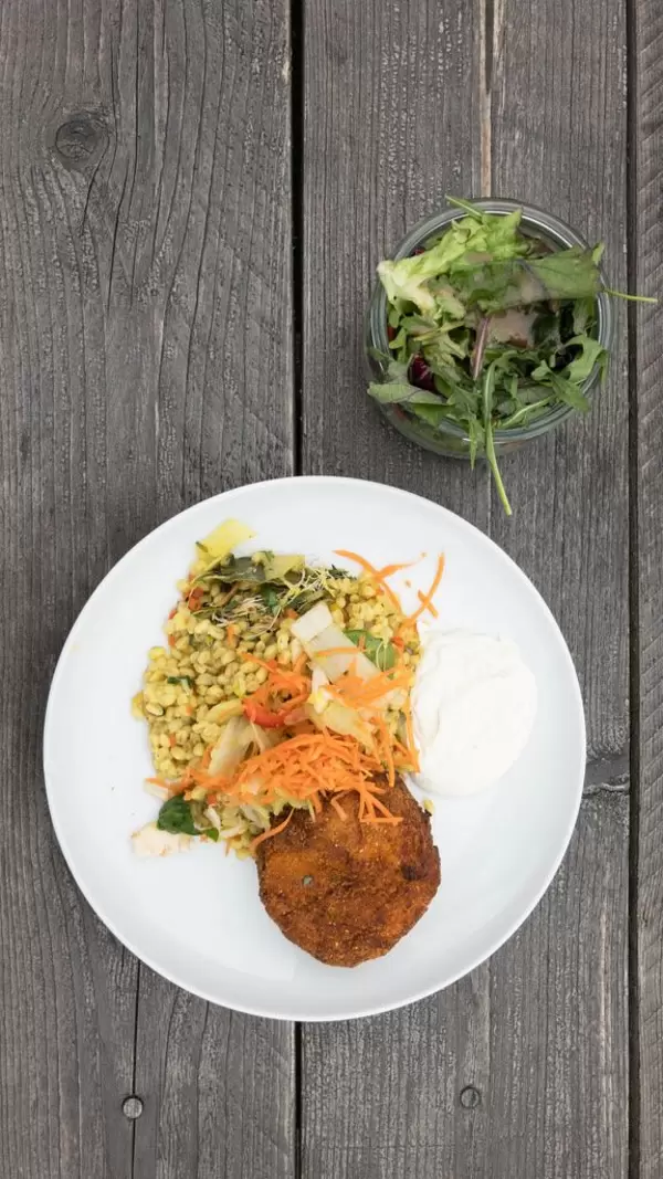 Top view of eggplant and potato croquettes with Ebly Zartweizen, veggie risotto with tarragon aioli and mixed salad