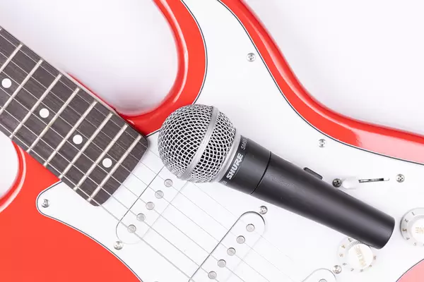 Top view of Electric Guitar and Shure Microphone