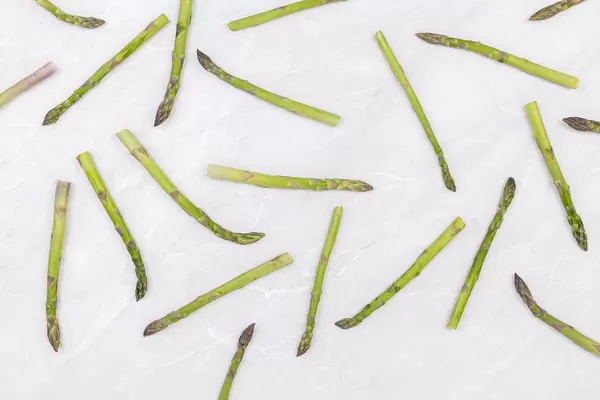 Top view of Fresh Asparagus above grey marble table
