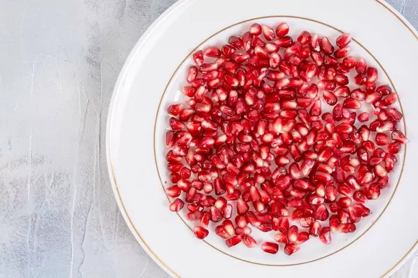 Top view of Fresh Pomegranate on the white plate
