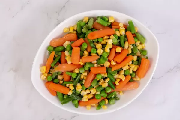 Top view of Fresh raw Carrot Peas Corn and Green Beans