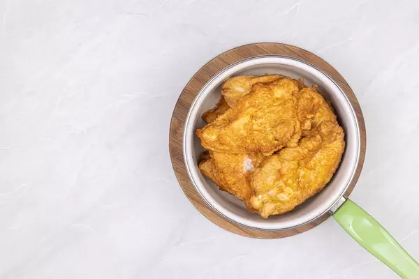 Top view of fried chicken breasts in the bowl