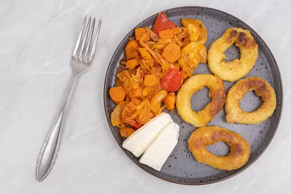 Top view of Fried Fish Rings with cheese and Vegetables
