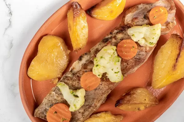 Top view of Fried Pork Steak and Potatoes with Carrot and Cauliflower