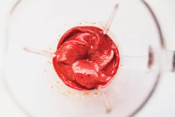 Top view of frozen banana berries smoothie in blender