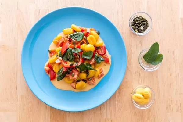 Top view of Gnocchi with pumpkin seeds in pepper sauce with ingredients