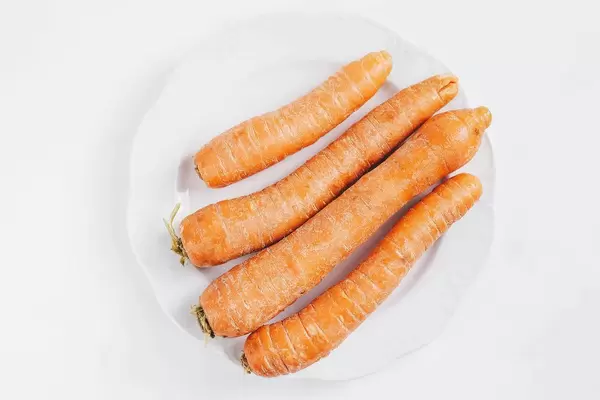 Top view of group of carrots on white background