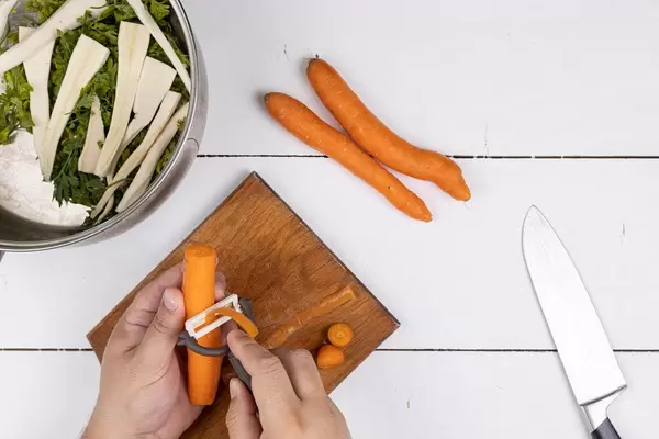 Top view of hand cleaning Carrot for the soup