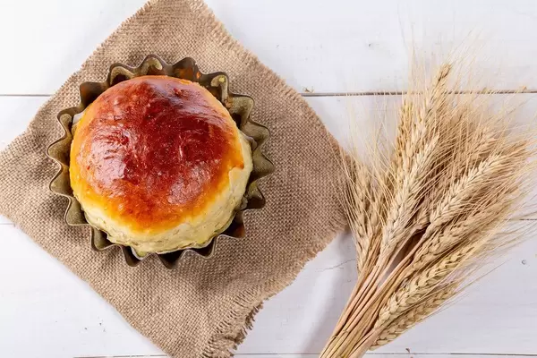 Top view of homemade bread with wheat spikelets