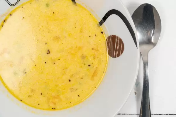 Top view of Homemade Chicken Soup with Carrot and Green Beans (Flip 2020)