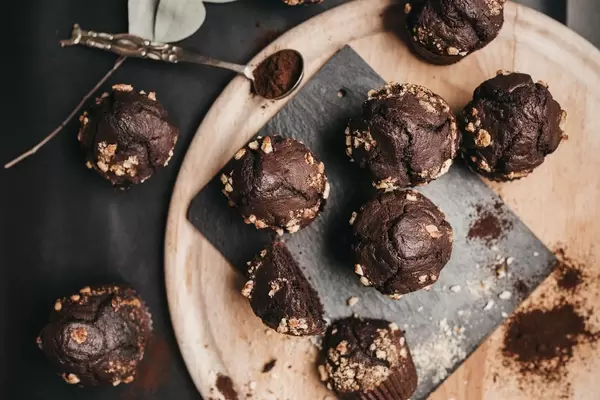 Top view of homemade chocolate muffins on wooden board. Food styling