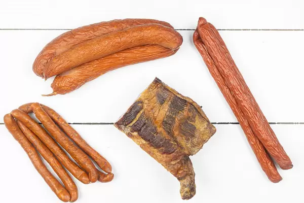 Top view of homemade Sausages and Bacon on the table