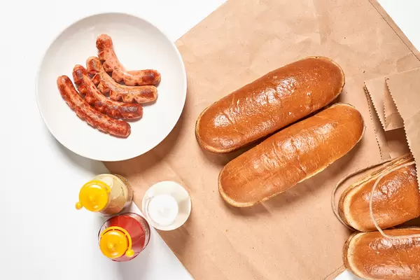Top view of hotdog ingredients on white table