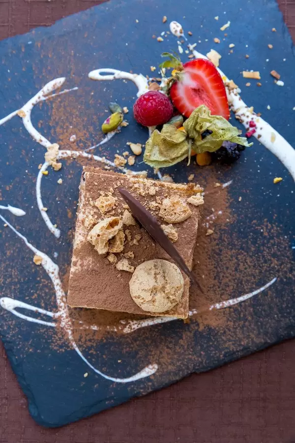 Top view of Italian tiramisu with hazelnut cream and crunchy chocolate. Q11 restaurant, Pollença, Majorca