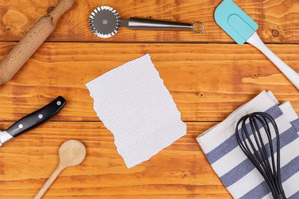Top view of Kitchen Utensils with copy space above white paper