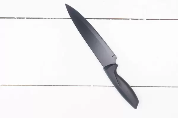 Top view of Knife on the white wooden table