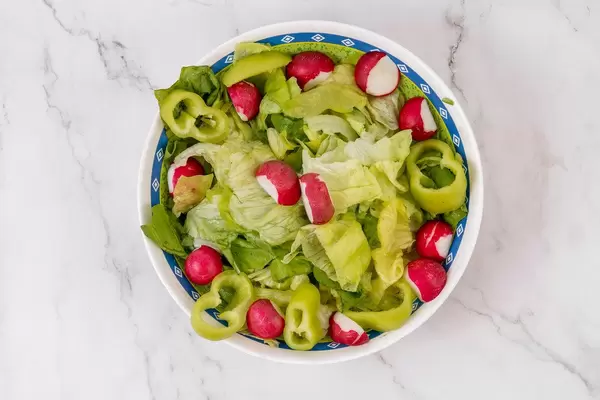 Top view of Lettuce salad with Red Radishes and Paprika (Flip 2019)