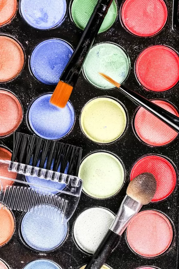 Top view of makeup eyeshadow palette with brush