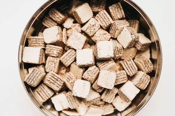 Top view of mini chocolate wafers in a box on white background