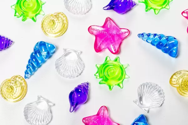 Top view of multicolored seashells on white background. Decoration for aquarium (Flip 2019)