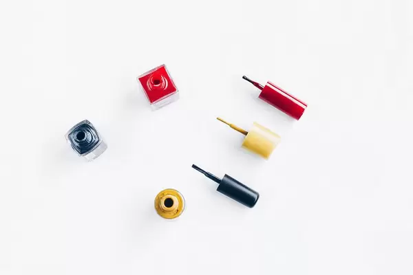 Top view of nail polish colors on white background