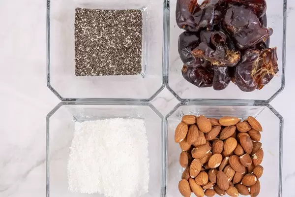 Top view of Peanut butter Almonds Coconut Chia Seeds and Dates