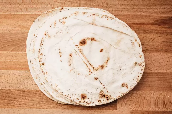 Top view of pita bread on wooden board