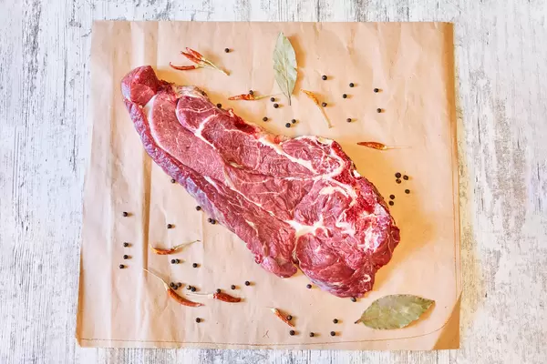 Top view of raw beef steak with spices