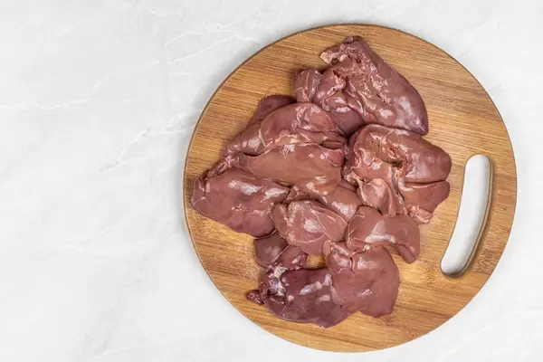 Top view of Raw Chicken Liver on the wooden board