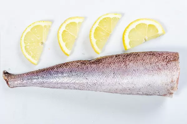 Top view of raw hake fish with lemon slices (Flip 2019)
