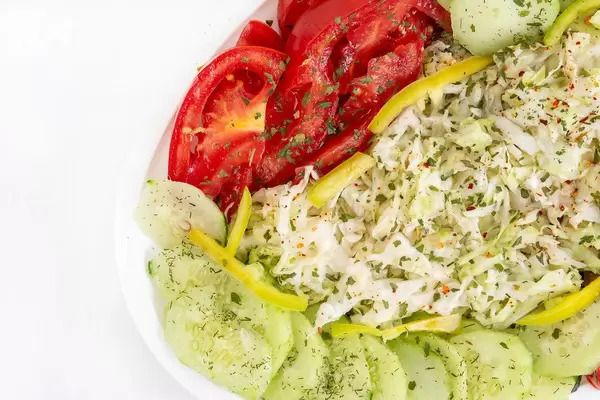 Top view of Salad with sliced Cabbage Tomato Cucumber and Paprika