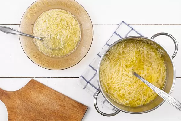 Top view of served Chicken Soup on the table