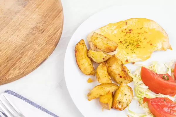 Top view of served meal with fried Chicken meat with Cheese