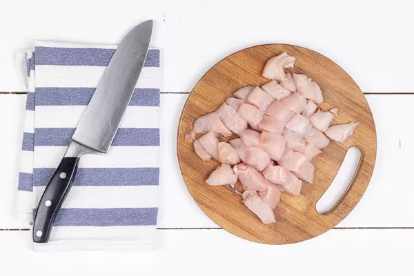 Top view of Sliced Chicken Breasts on the wooden board